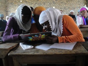 Two Ugandan students discussing ScienceGrrl calendar